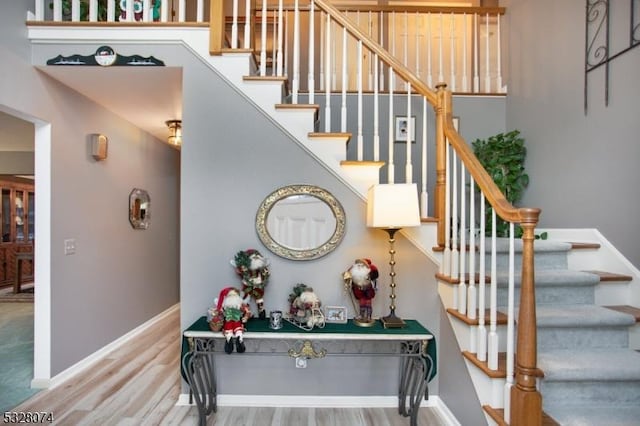 stairs with hardwood / wood-style flooring