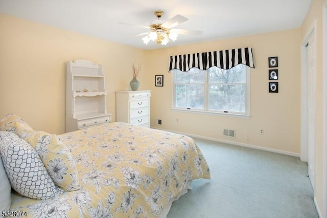 bedroom featuring light carpet and ceiling fan