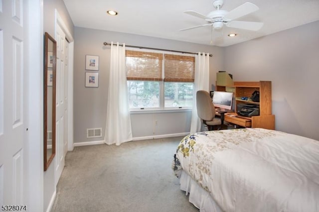 carpeted bedroom with ceiling fan and a closet