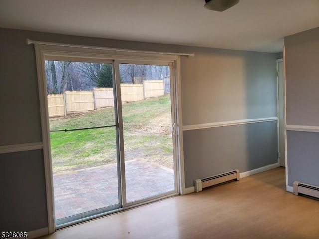 doorway to outside with baseboard heating and light wood-type flooring