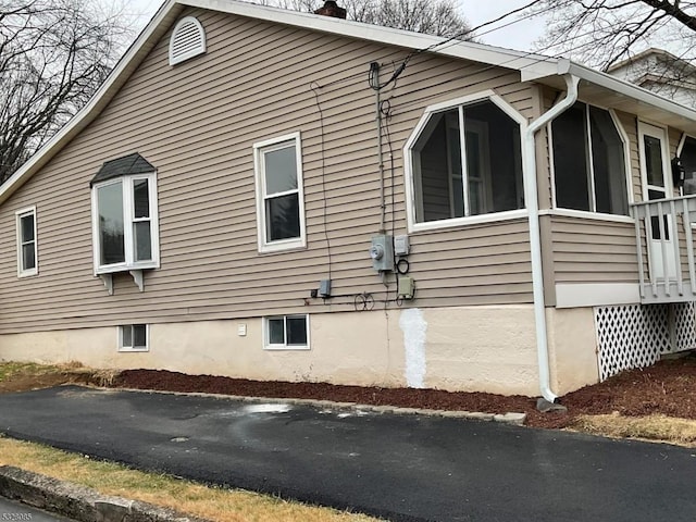 view of side of home with a sunroom