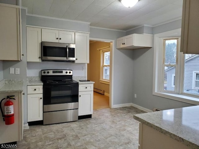 kitchen with a healthy amount of sunlight, ornamental molding, and appliances with stainless steel finishes