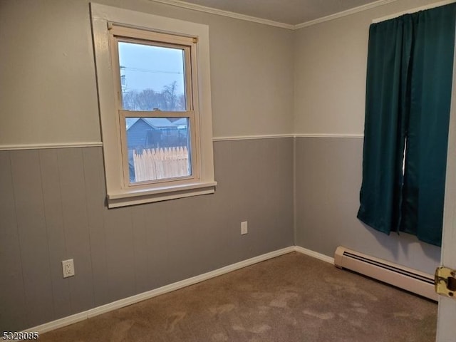 unfurnished room with crown molding, carpet, and a baseboard heating unit