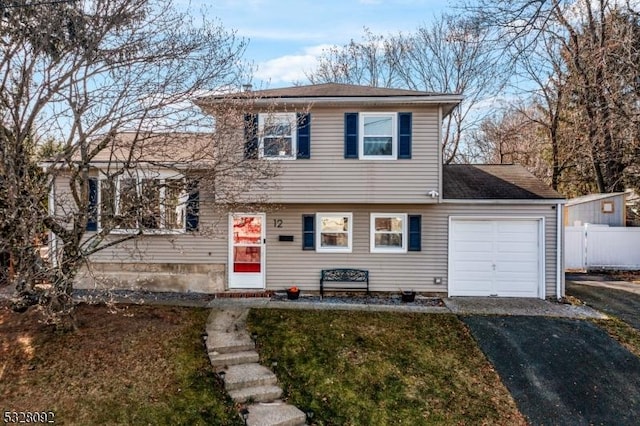 split level home featuring a front yard and a garage