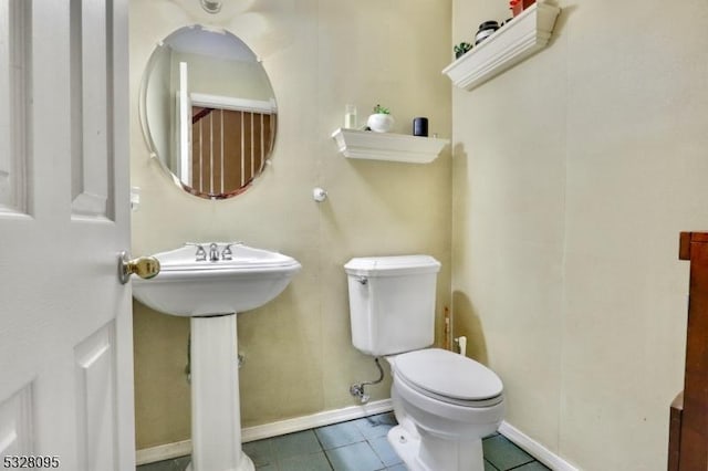 bathroom featuring toilet and tile patterned flooring