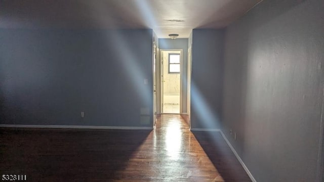 unfurnished room with dark hardwood / wood-style floors