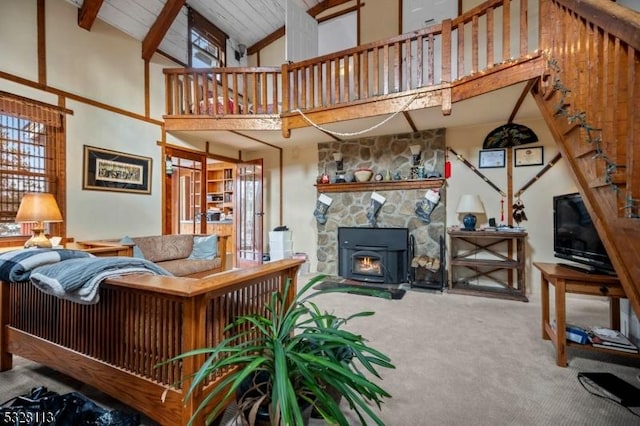 carpeted living room with beam ceiling and high vaulted ceiling