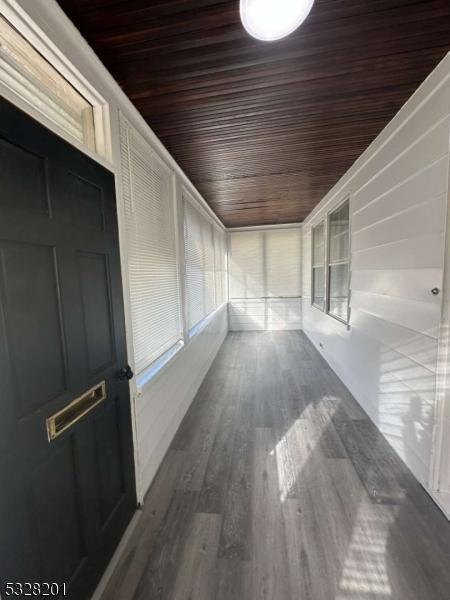 unfurnished sunroom with wood ceiling