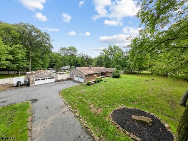 view of front of property with a garage and a front lawn