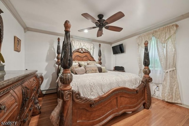 bedroom with hardwood / wood-style floors, ceiling fan, crown molding, and a baseboard heating unit