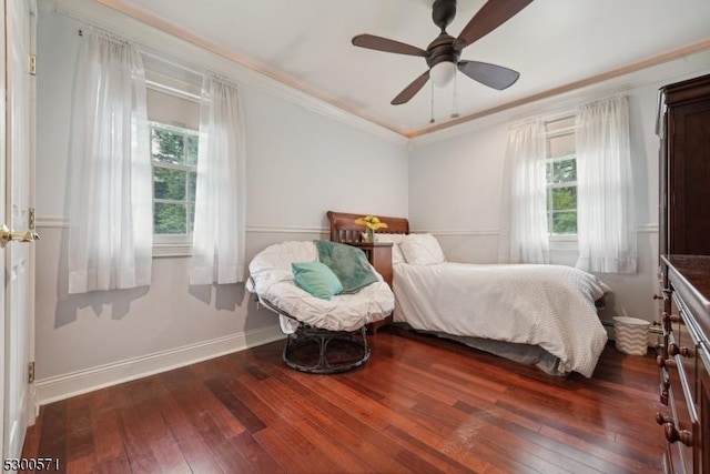 bedroom with ceiling fan, dark hardwood / wood-style floors, and ornamental molding