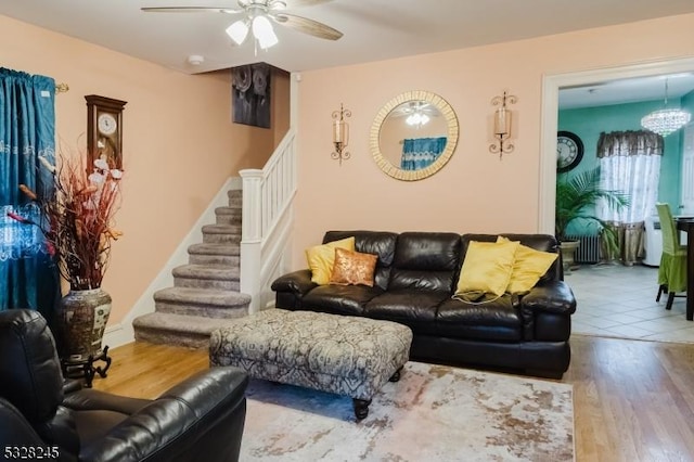 living room featuring hardwood / wood-style floors and ceiling fan