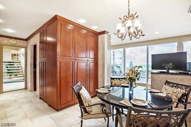 dining room featuring ornamental molding and an inviting chandelier