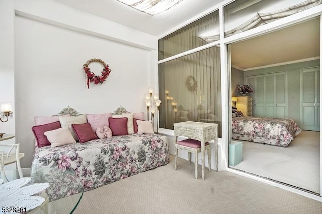 bedroom featuring carpet flooring, a closet, and crown molding