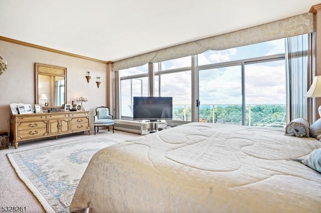 bedroom featuring access to exterior, crown molding, and carpet