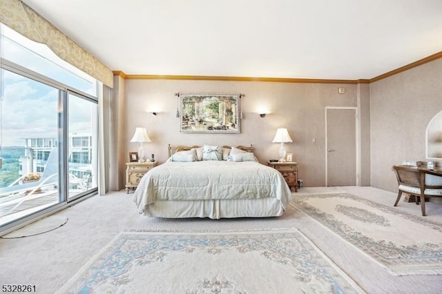 carpeted bedroom featuring multiple windows, access to exterior, and ornamental molding