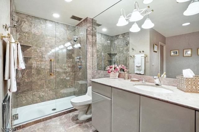 bathroom featuring vanity, an enclosed shower, and toilet