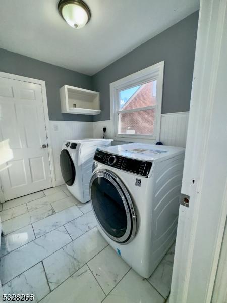 laundry area with washing machine and clothes dryer