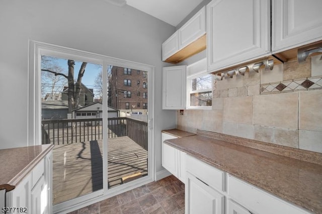 kitchen featuring stone countertops and white cabinetry