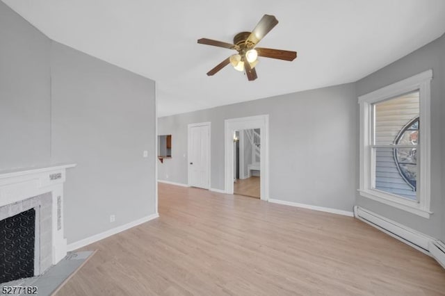 unfurnished living room with light hardwood / wood-style flooring, ceiling fan, and a baseboard heating unit