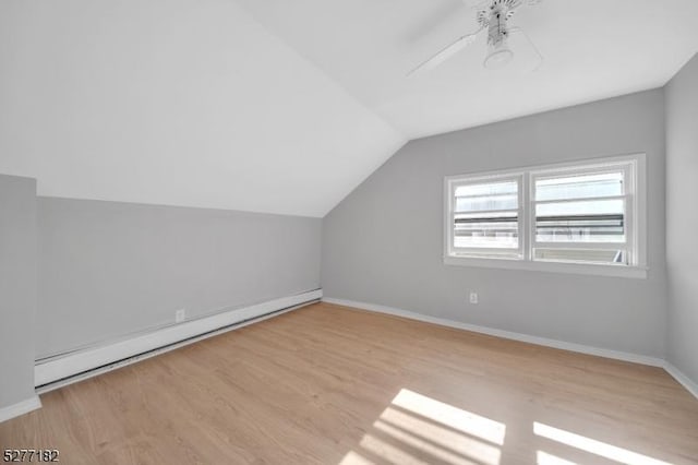 bonus room featuring ceiling fan, light wood-type flooring, baseboard heating, and vaulted ceiling