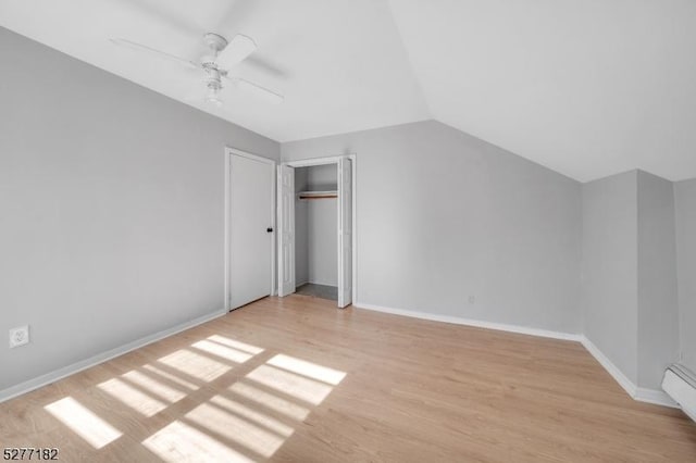 additional living space with light hardwood / wood-style floors, ceiling fan, and lofted ceiling