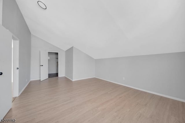 bonus room with light hardwood / wood-style floors and lofted ceiling