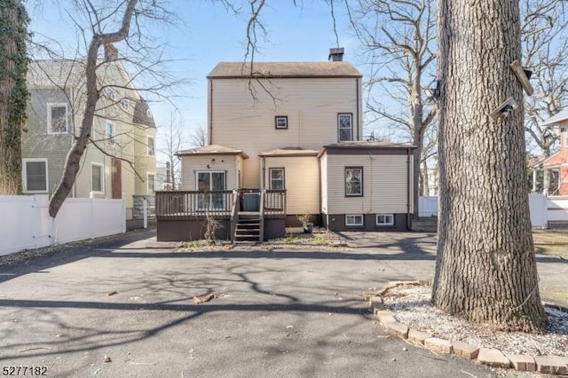 back of house featuring a wooden deck