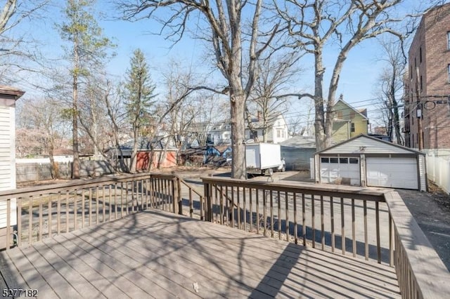 wooden deck featuring an outbuilding and a garage