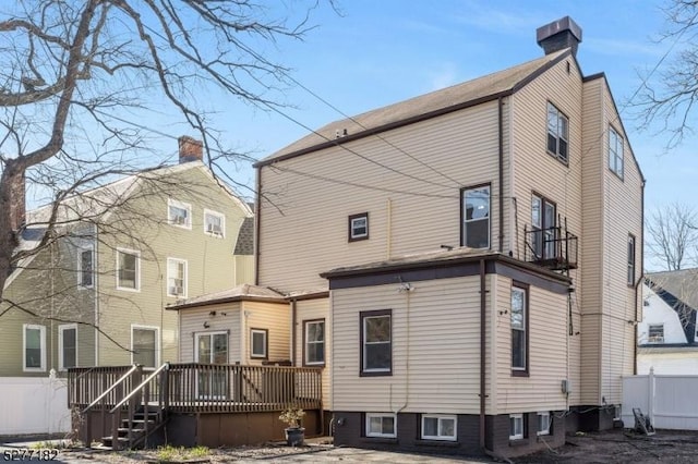 rear view of property featuring a deck