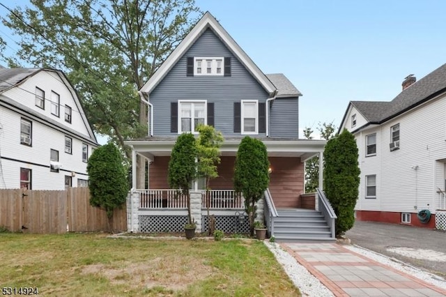 view of front property featuring a porch and a front lawn