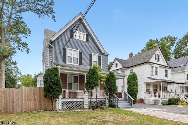 front facade with a porch and a front yard