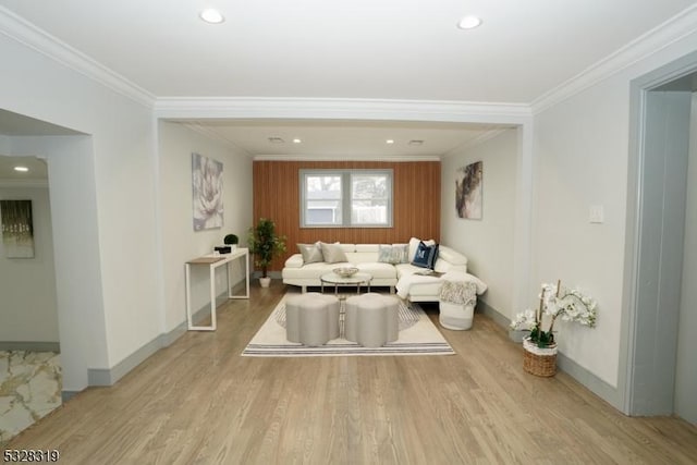 living room featuring ornamental molding and light wood-type flooring