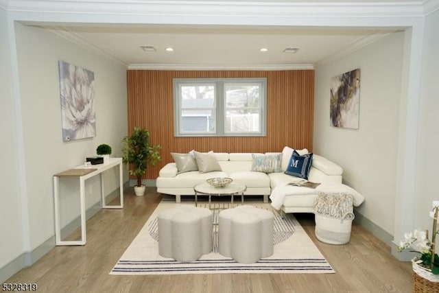 living area featuring light hardwood / wood-style flooring and ornamental molding