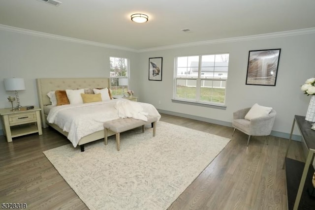 bedroom featuring dark hardwood / wood-style flooring and ornamental molding