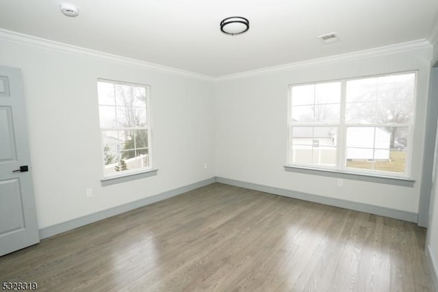 unfurnished room with wood-type flooring and crown molding