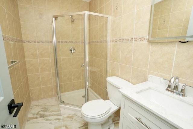 bathroom featuring vanity, toilet, an enclosed shower, and tile walls