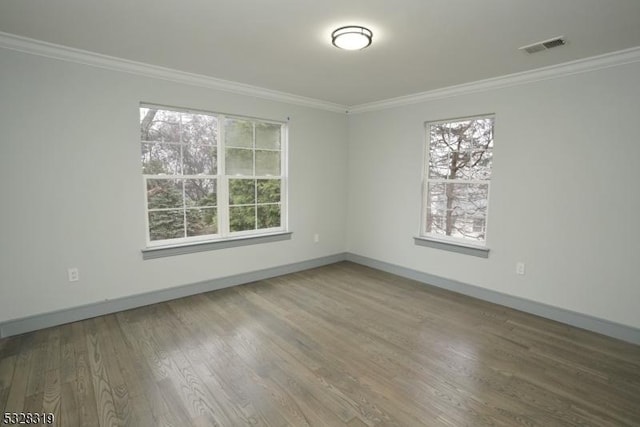 unfurnished room featuring hardwood / wood-style floors and ornamental molding