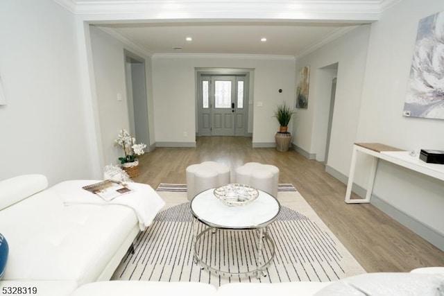 living room with crown molding and light wood-type flooring