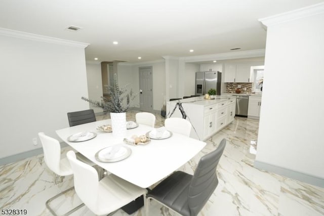 dining area with crown molding