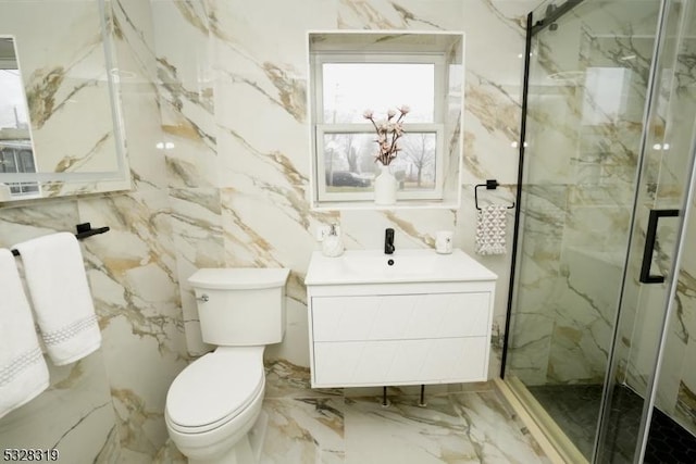 bathroom featuring vanity, a shower with shower door, tile walls, and toilet