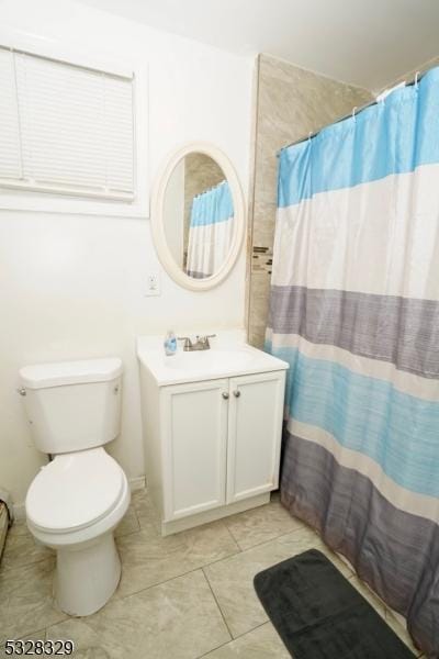 bathroom featuring tile patterned floors, a shower with curtain, toilet, and vanity