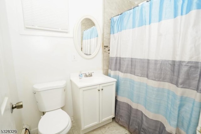 bathroom featuring a shower with shower curtain, vanity, toilet, and tile patterned floors