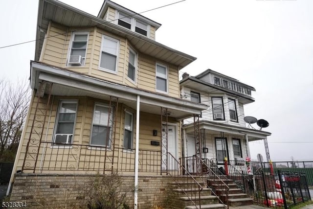 view of front facade with cooling unit and covered porch