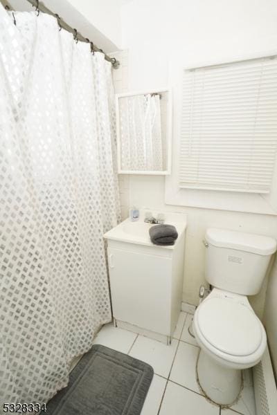 bathroom featuring tile patterned flooring and toilet