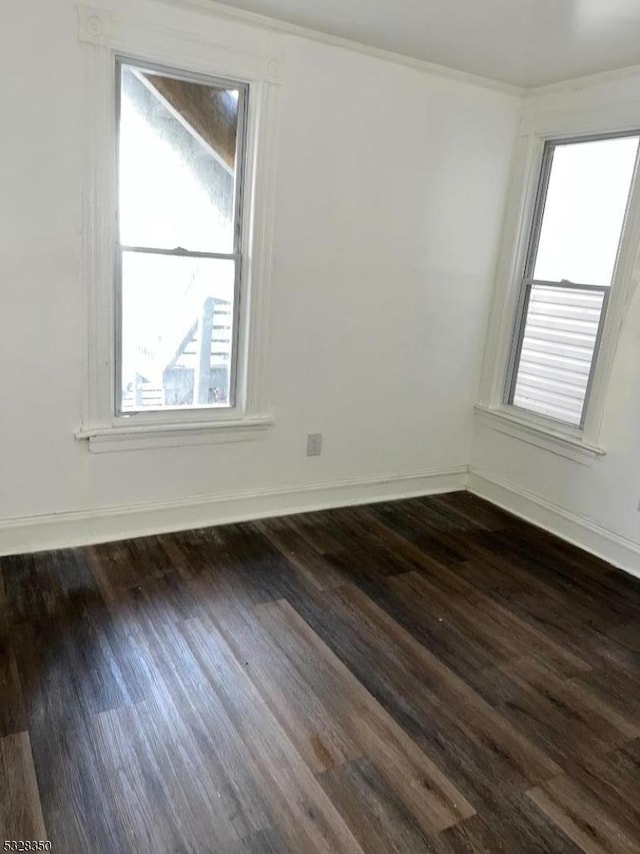 empty room with dark wood-type flooring