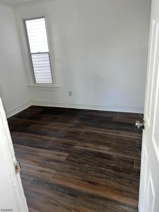 spare room with dark wood-type flooring