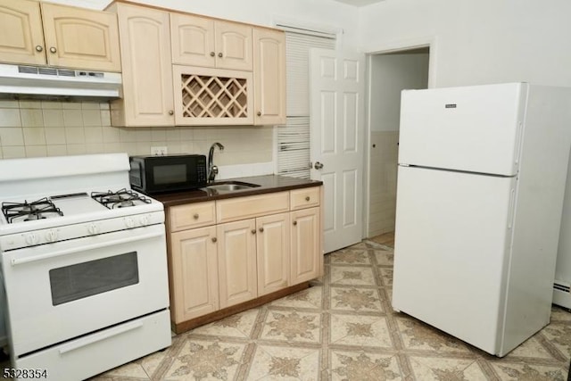 kitchen featuring tasteful backsplash, sink, and white appliances