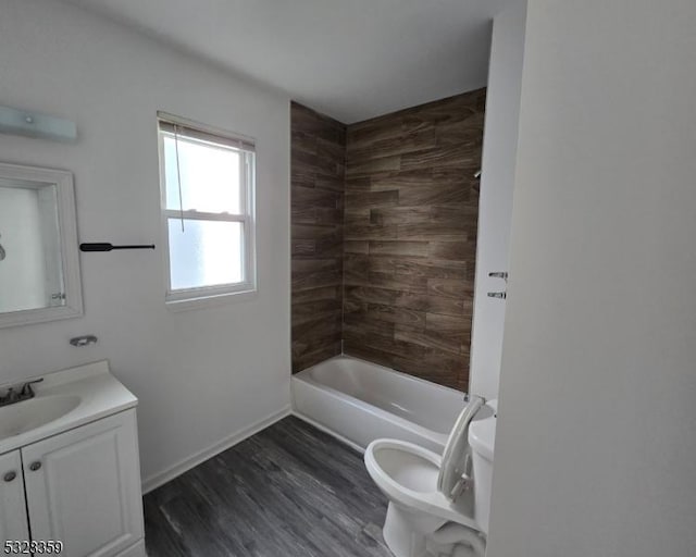 full bathroom with hardwood / wood-style floors, vanity, toilet, and shower / washtub combination