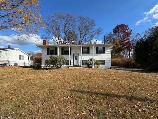 bi-level home with a front lawn